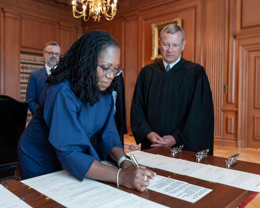Chief Justice of the United States John G. Roberts, Jr., looks on as Justice Ketanji Brown Jackson signs the Oaths of Office in the Justices Conference Room, Supreme Court Building. Copyright: xFredxSchilling,xCollectionxofxthexSupremexCourtxofxthexUnitedxStatesxviaxConsolidatedxNewsxPhotosx