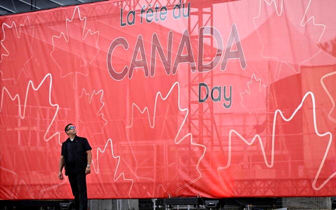 July 1, 2022, Ottawa, ON, CAN: A member of the police protective detail looks up at a Canada Day sign before the start of Canada Day celebrations at Lebreton Flats in Ottawa, on Friday, July 1, 2022. Ottawa CAN  - ZUMAc35_ 20220701_zaf_c35_031 Copyright: xJustinxTangx