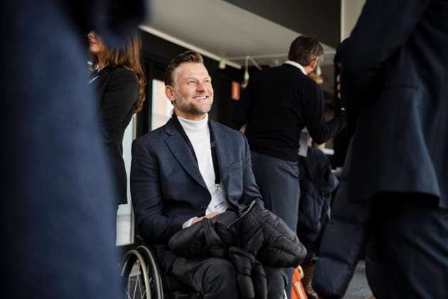 Smiling disabled businessman sitting in wheelchair looking at male delegate during seminar Sweden, Stockholm, model released, property released Copyright: xMaskotx , MA93516 MA93516