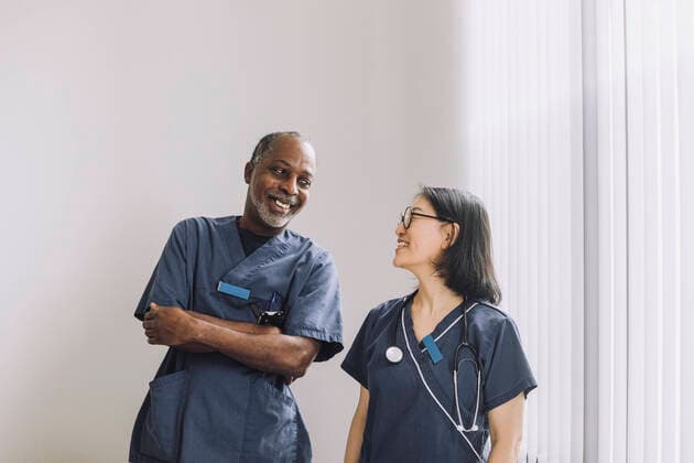 Creative Highlights Symbolbilder Happy healthcare experts looking at each other against white wall in hospital Sweden, Stockholm, model released, property released Copyright: xMaskotx , MA94558 MA94558