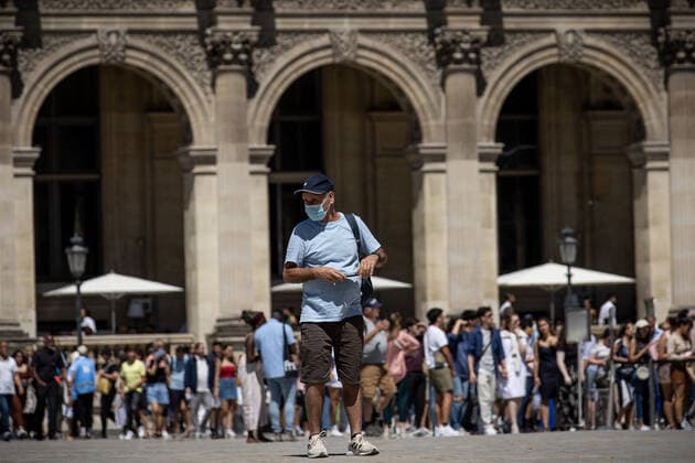 (220709) -- PARIS, July 9, 2022 -- A man wearing a face mask walks in front of the Louvre Museum in Paris, France, July 8, 2022. The total number of COVID-19 related deaths in France passed the 150,000 mark on Friday, after 74 deaths related to the virus were recorded in hospitals in the past 24 hours, announced the country s public health agency. (Photo by Xinhua) FRANCE-PARIS-COVID-19-DEATH AurelienxMorissard 