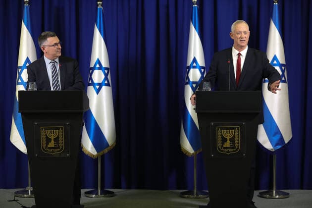 (220711) -- RAMAT GAN, July 11, 2022 -- Benny Gantz (R), Israel s defense minister and leader of the centrist Blue and White party, and Gideon Sa ar, justice minister and leader of the right-wing New Hope party attend a joint press conference in central Israeli city of Ramat Gan on July 10, 2022. Leaders of two parties in Israel s outgoing coalition government announced on Sunday that they would run jointly in the upcoming national elections. Benny Gantz and Gideon Sa ar called in a joint statement for a centrist unity government with Gantz at the helm that would say no to extremism. ( JINI via Xinhua) ISRAEL-RAMAT GAN-GANTZ-SAAR-JOINT PRESS CONFERENCE GideonxMarkowicz 