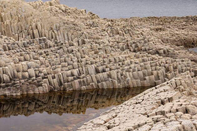 Creative Highlights World SAKHALIN REGION, RUSSIA - JULY 8, 2022: Cape Stolbchaty of Kunashir Island. The cape consists of columnar basalt volcanic rock formations. Kunashir is the largest and southernmost island of the Kuril Islands archipelago. Yuri Smityuk TASS  TS139D14