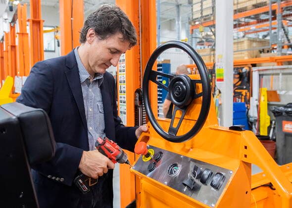 July 12, 2022, Sherbrooke, PQ, Canada: Prime Minister Justin Trudeau drills a screw into the front panel of a vehicle during a tour of Motrec, a heavy-duty electric vehicle production facility in Sherbrooke, Que., Tuesday, July 12, 2022. Sherbrooke Canada  - ZUMAc35_ 20220712_zaf_c35_018 Copyright: xGrahamxHughesx