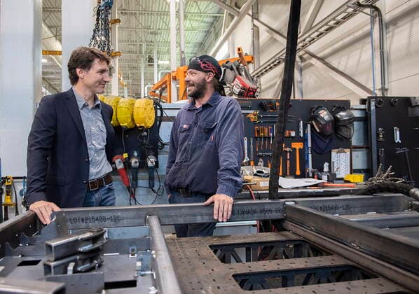 July 12, 2022, Sherbrooke, PQ, Canada: Prime Minister Justin Trudeau talks with a worker during a tour of Motrec, a heavy-duty electric vehicle production facility in Sherbrooke, Que., Tuesday, July 12, 2022. Sherbrooke Canada  - ZUMAc35_ 20220712_zaf_c35_021 Copyright: xGrahamxHughesx