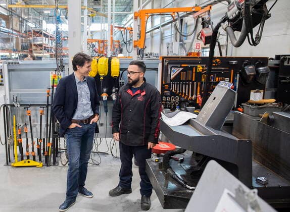 July 12, 2022, Sherbrooke, PQ, Canada: Prime Minister Justin Trudeau talks with to a worker during a tour of Motrec, a heavy-duty electric vehicle production facility in Sherbrooke, Que., Tuesday, July 12, 2022. Sherbrooke Canada  - ZUMAc35_ 20220712_zaf_c35_022 Copyright: xGrahamxHughesx
