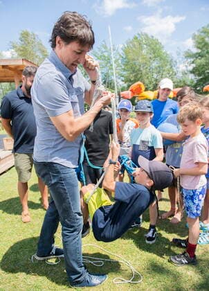 July 12, 2022, Magog, PQ, Canada: Prime Minister Justin Trudeau lifts a young boy up with a rope during a visit to a sailing camp in Magog, Que., Tuesday, July 12, 2022. Magog Canada  - ZUMAc35_ 20220712_zaf_c35_048 Copyright: xGrahamxHughesx