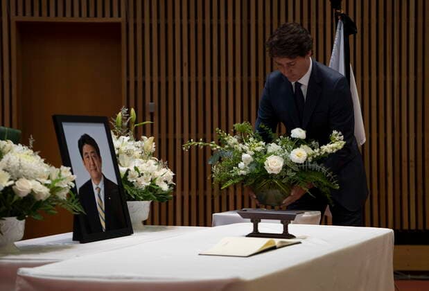 July 12, 2022, Ottawa, ON, Canada: Canadian Prime Minister Justin Trudeau places flowers on a table before signing a book of condolences for former Japanese Prime Minister Shinzo Abe at the Japanese embassy, Tuesday, July 12, 2022 in Ottawa. Ottawa Canada  - ZUMAc35_ 20220712_zaf_c35_099 Copyright: xAdrianxWyldx