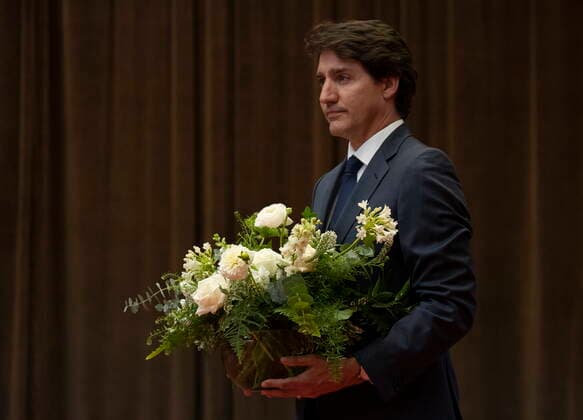 July 12, 2022, Ottawa, ON, Canada: Canadian Prime Minister Justin Trudeau carries flowers before signing a book of condolences for former Japanese Prime Minister Shinzo Abe at the Japanese embassy, Tuesday, July 12, 2022 in Ottawa. Ottawa Canada  - ZUMAc35_ 20220712_zaf_c35_108 Copyright: xAdrianxWyldx