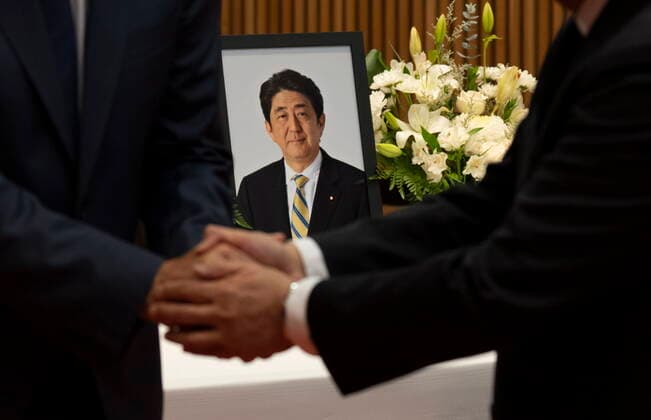 July 12, 2022, Ottawa, ON, Canada: Japanese Ambassador to Canada Kanji Yamanouchi shakes hands with Prime Minister Justin Trudeau after Trudeau signed a book of condolences for former Japanese Prime Minister Shinzo Abe at the Japanese embassy, Tuesday, July 12, 2022 in Ottawa. Ottawa Canada  - ZUMAc35_ 20220712_zaf_c35_109 Copyright: xAdrianxWyldx
