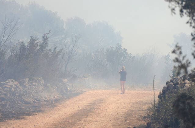 PXL_A fire near Vodice, Croatia Fire in an open area near the Velika Mrdakovica archaeological site in the Vodice hinterland, Croatia on July 13, 2022. About 30 firefighters with a dozen vehicles are on the ground, and two Canadairs joined the ground forces in extinguishing the fire. There are pine forests above, low vegetation, and endangered buildings. DuskoxJaramaz PIXSELL