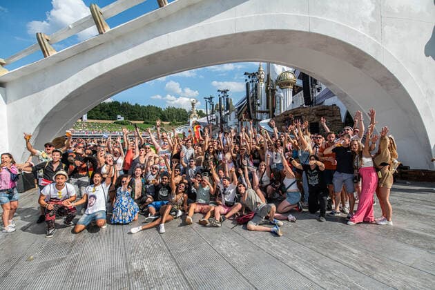 A group of festival goers poses for the photographer during the first day of the Tomorrowland electronic music festival, Friday 15 July 2022, in Boom. The 16th edition of the festival takes place on three weekends at the De Schorre terrain in Boom, from 15 to 17 July, from 22 to 24 July 2022 and from 29 to 31 July. The festival had to be postponed for two years in the ongoing corona virus pandemic.  JONASxROOSENS 37512135
