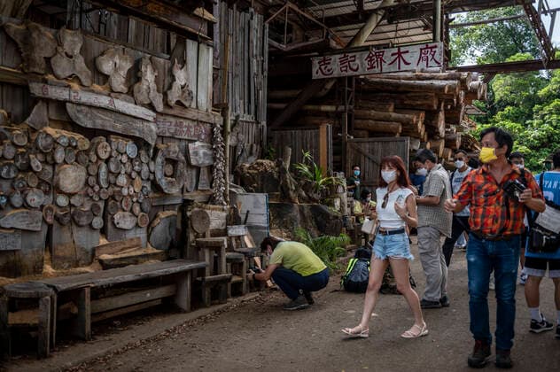 Hong Kong Sawmill Ask To Vacated By Government For Public Housing People walking pass Chi Kee Sawmill and Timber in Kwu Tung on July 16, 2022 in Hong Kong, China. The 40 Year Old Business Chi Kee Sawmill and Timber which is located in Kwu Tung is one of the few woodwork factory still operating in Hong Kong, Its has been ask to move by the Hong Kong Government to make way for new development. Hong Kong Hong Kong  Copyright: xVernonxYuenx originalFilename: yuen-hongkong220716_npOiO.jpg