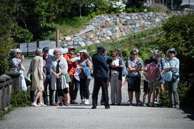 July 19, 2022, BOWEN ISLAND, BC, CANADA: A member of Prime Minister Justin Trudeau s RCMP security detail stands in front of local residents as they wait for him to arrive for a news conference on Bowen Island, B.C., on Tuesday, July 19, 2022. BOWEN ISLAND CANADA  - ZUMAc35_ 20220719_zaf_c35_014 Copyright: xDarrylxDyckx