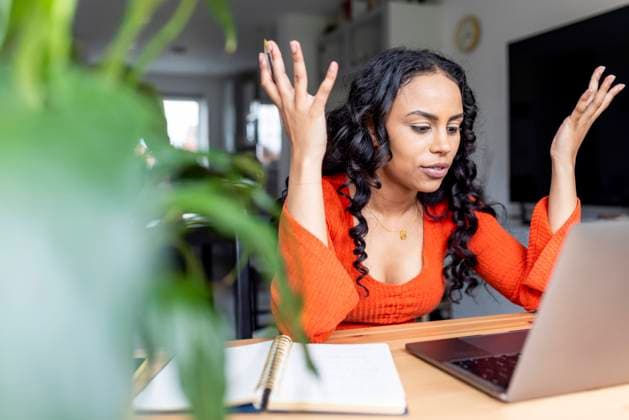 Woman gesturing and talking on video call over laptop at home office model released, Symbolfoto property released, WPEF05993