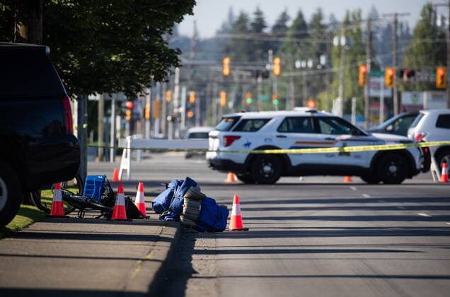 July 25, 2022, LANGLEY, BC, CANADA: A bike and person s belongings are seen on the sidewalk behind police tape at the scene of a shooting, in Langley, B.C., on Monday, July 25, 2022. A suspect is in custody after several people were shot in the Metro Vancouver city of Langley, RCMP said. Police issued a blaring cellphone alert at about 6:20 Monday morning, saying they were at the scenes of several shootings involving transient victims. LANGLEY CANADA - ZUMAc35_ 20220725_zaf_c35_110 Copyright: xDarrylxDyckx