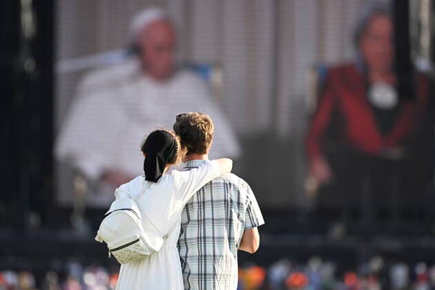 July 27, 2022, QUEBEC, QC, CANADA: Pope Francis is seen on a TV screen on the Plaines döÄÃ Abraham while an unidentified couple is watching during his Papal visit across Canada in Quebec City on Wednesday, July 27, 2022. QUEBEC CANADA  - ZUMAc35_ 20220727_zaf_c35_093 Copyright: xBernardxBraultx