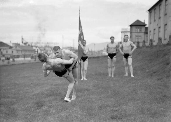 Poll photo collection. Iceland. Reykjavik. Icelandic wrestling (Glima). Two members of the Glimateam of the Menntaskolinn in Aktie. The other team members, one with a banner, look. 1934. Iceland, Reykjavik Copyright: xpiemagsx pienatarchpart630102021-18603 !ACHTUNG AUFNAHMEDATUM GESCHÄTZT!