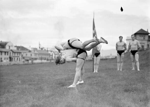 Poll photo collection. Iceland. Reykjavik. Icelandic wrestling (Glima). Two members of the Glimateam of the Menntaskolinn in Aktie. The other team members, one with a banner, look. 1934. Iceland, Reykjavik Copyright: xpiemagsx pienatarchpart630102021-18608 !ACHTUNG AUFNAHMEDATUM GESCHÄTZT!