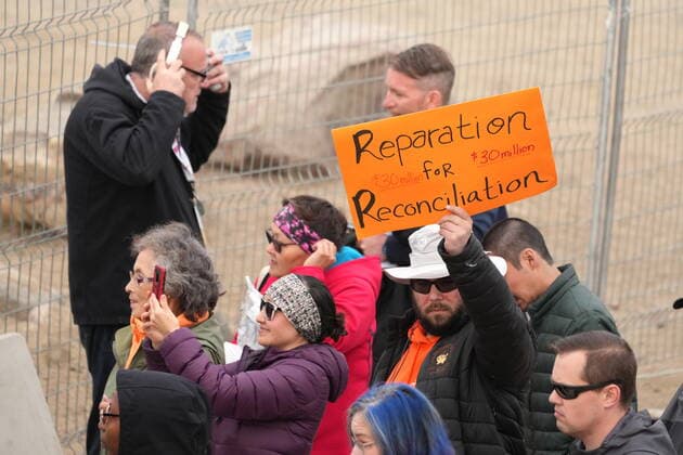 July 29, 2022, IQALUIT, NU, CANADA: A protestor holds a sign as Pope Francis arrives for a public event in Iqaluit, Nunavut on Friday, July 29, 2022, during his papal visit across Canada. IQALUIT CANADA  - ZUMAc35_ 20220729_zaf_c35_072 Copyright: xNathanxDenettex