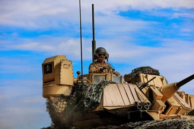 July 13, 2022 - Drawsko Pomorskie, Poland - Spc. Kenneth Black, assigned to Chaos Company, 1st Battalion, 68th Armor Regiment, 3rd Armored Brigade Combat Team, 4th Infantry Division, directs a M2A3 Bradley Fighting Vehicle into position to recover a squad as they conclude a squad live-fire exercise at Drawsko Pomorskie, Poland, July 13, 2022. The 3rd Armored Brigade Combat Team, 4th Infantry Division, is among other units assigned to the 1st Infantry Division, proudly working alongside NATO allies and regional security partners to provide combat-credible forces to V Corps, America s forward-deployed corps in Europe. Drawsko Pomorskie Poland - ZUMAz03_ 20220713_stw_z03_804 Copyright: xU.S.xArmyx