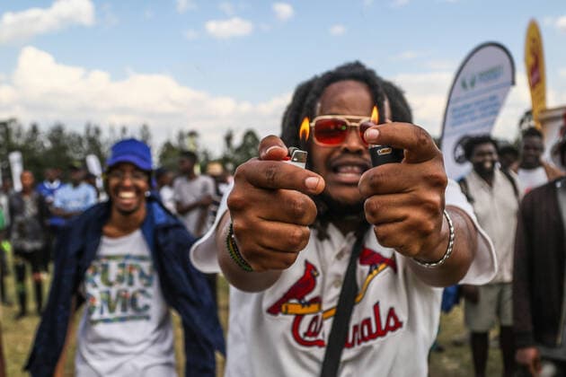 July 30, 2022, Nakuru, Rift Valley, Kenya: A man holds two lit cigarette lighters at a peace concert held to preach peace and harmony ahead of Kenya s August General Election. Kenyans will be going to the polls to choose their preferred president and members of both the national and county assemblies. Nakuru Kenya - ZUMAs197 20220730_zaa_s197_048 Copyright: xJamesxWakibiax
