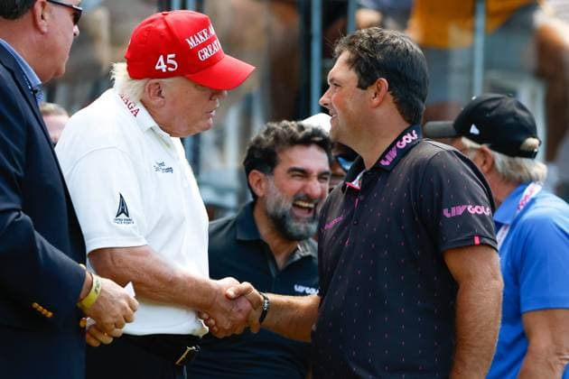 BEDMINSTER, NJ - JULY 30: Former President Donald Trump shakes hands with Patrick Reed at the 1st tee prior to the start of the second round of LIV golf invitational series on July 30, 2022 in Bedminster, New Jersey. (Photo by Rich Graessle Icon Sportswire) Icon1013521847