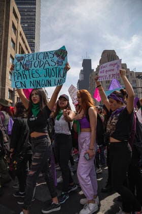 A protester carrying a poster with Police everywhere. Justice nowhere written on it. In Mexico at least 10 women are killed everyday and there is a big gender inequality. At this march women mainly were dressed with purple, green and black. Purple symbolizes the rejection to violence against women, green symbolizes the right of women to decide about her own body and life, and black for mourning. Mexico. AlejandroxParis xMajorityxWorld 3 8 2020 925_02_MWC046113