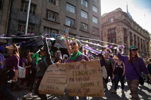 A group of women during a Feminist March with over 80,000 participants in Mexico city. In Mexico at least 10 women are killed everyday and there is a big gender inequality. At this march women mainly were dressed with purple, green and black. Purple symbolizes the rejection to violence against women, green symbolizes the right of women to decide about her own body and life, and black for mourning. Mexico. AlejandroxParis xMajorityxWorld 3 8 2020 925_02_MWC046122