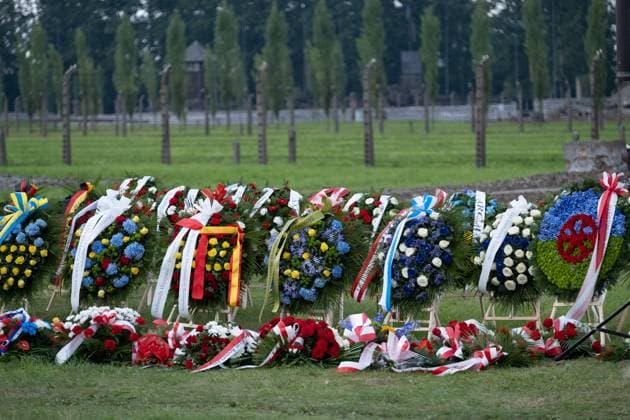 March 11, 2000, Brzezinka, Poland: Wreaths and flowers lay on the grass at former camp Auschwitz II Birkenau. Roma and Sinti Genocide Remembrance Day. 78 years ago, on the night of 2 to 3 August 1944, the Germans liquidated the camp for Gypsies (Zigeunerfamilienlager) in KL Auschwitz II Birkenau. The anniversary was organised at the former camp Auschwitz II-Birkenau. Brzezinka Poland - ZUMAs197 20000311_zaa_s197_004 Copyright: xWojciechxGrabowskix