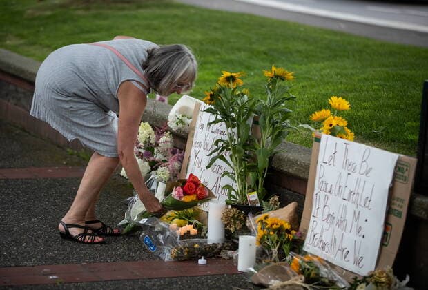 August 3, 2022, LANGLEY, BC, CANADA: Lorraine Furness places flowers at a memorial for her son Steven Furness and Paul Wynn, after a vigil for the two men who were killed by a gunman during a series of attacks on homeless people last month, in Langley, B.C., on Wednesday, August 3, 2022. The suspect believed to be responsible for the shooting of four people, including the two fatalities, was shot and killed by the RCMP. LANGLEY CANADA - ZUMAc35_ 20220803_zaf_c35_075 Copyright: xDarrylxDyckx