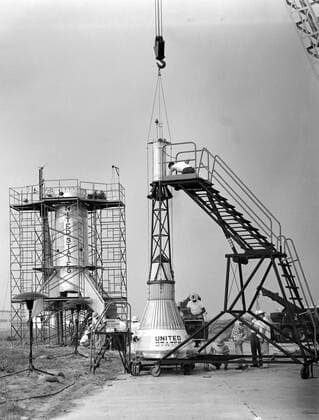 Technicians adjust the rocket motor during the attachment of the escape tower to the Mercury capsule prior to assembly with Little Joe launcher, August 20, 1959. Joseph Shortal wrote (vol. 3., p. 33): The escape tower and rocket motors were taken from the Mercury capsule production. The tower is shown being attached to the capsule.... The escape rocket was a Grand Central 1-KS-52000 motor with three canted nozzles. The tower-jettison motor was an Atlantic Research Corp. 1.4-KS-785 motor. This was the same design tested in a beach abort test...and had the offset thrust line as used in the beach abort test to insure that the capsule would get away from the booster in an emergency. The escape system weighed 1,015 pounds, including 236 pounds Copyright: xpiemagsx piemagsspace-679 !ACHTUNG AUFNAHMEDATUM GESCHÄTZT!