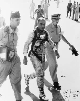 S61-02894 (21 July 1961) --- Astronaut Virgil I. (Gus) Grissom, pilot of the Mercury-Redstone 4 (MR-4) Liberty Bell 7 spaceflight, arrives aboard the recovery ship, USS Randolph, following his 15-minute, 37-second suborbital space mission. He is flanked by military medical officers. Copyright: xpiemagsx piemagsspace-54384 !ACHTUNG AUFNAHMEDATUM GESCHÄTZT!