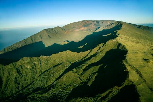Creative Highlights World Aerial view of green mountain with Pacific ocean in background in Maui, Hawaii.  Copyright: RonxChapplexStock 30248974