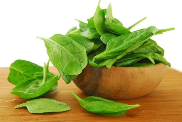 Fresh spinach iin a wooden bowl on a cutting board  Copyright: ElenaxElisseeva 30257085