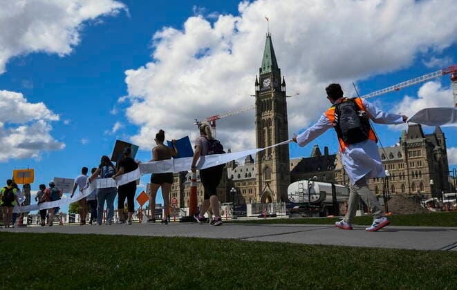 August 11, 2022, Ottawa, ON, CAN: Scientists and researchers hold a petition with over 7,100 signatures calling on the federal government to increase funding for graduate and post-doctoral scholars, during the öÄuSupport Our ScienceöÄÃ¹ rally on Parliament Hill in Ottawa, on Thursday, Aug. 11, 2022. Ottawa CAN  - ZUMAc35_ 20220811_zaf_c35_036 Copyright: xJustinxTangx