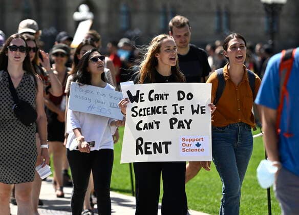 August 11, 2022, Ottawa, ON, CAN: Scientists and researchers rally on Parliament Hill to call on the federal government to increase funding for graduate and post-doctoral scholars, during the öÄuSupport Our ScienceöÄÃ¹ rally on Parliament Hill in Ottawa, on Thursday, Aug. 11, 2022. Ottawa CAN  - ZUMAc35_ 20220811_zaf_c35_044 Copyright: xJustinxTangx