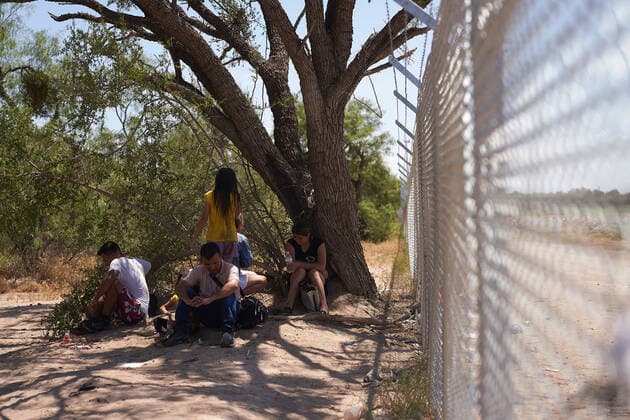 August 11, 2022, Eagle Pass, Texas, US: A group of migrants wait to be processed by U.S. Border Patrol after illegally crossing the Rio Grande River from Mexico onto private property in Eagle Pass, Texas on Thursday August 11, 2022. Eagle Pass US - ZUMAd211 20220811_zap_d211_030 Copyright: xAllisonxDinnerx