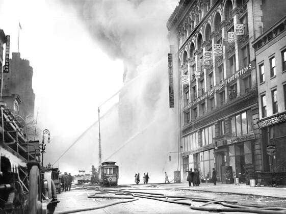 May 2, 2022, New York City, New York, USA: Fireman spraying water on burning building, 14th Street, New York City, New York, USA, Bain News Service, December 1909 New York City USA - ZUMAg145 20220502_zap_g145_003 Copyright: xJTxVintagex