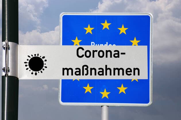 Symbol image corona measures road sign with the inscription corona measures in front of a German border sign Copyright: xx