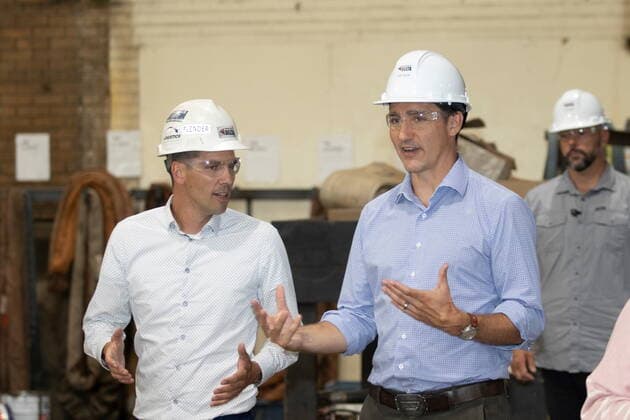 August 18, 2022, New Richmond, PQ, CANADA: Prime Minister Justin Trudeau, right, tours headquarters of Fabrication Delta, a company that makes wind turbine towers and other large steel structures in New Richmond, Quebec on Thursday Aug. 18, 2022. Trudeau continued his summer politicking tour Thursday with a trip to Quebec s Gaspe Peninsula. New Richmond CANADA  - ZUMAc35_ 20220818_zaf_c35_036 Copyright: xRonxWardx