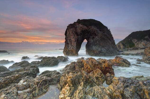 Creative Highlights World The magnificent natural rock structure, Horse Head Rock, which lies in the beautiful coastal fishing village of Bermagui. The rock has weathered by the forces of nature over time and resembles a horse drinking water. Behind the sky lights up in hues of red orange and blue and in the foreground sharp volcanic rocks and rockpools wet with the surging seas , 17038242.jpg, Horse Head Rock, Bermagui, beach, geology, erosion, nature, travel, scenic, view, holiday, vacation, scenery, seascape, landscape, sky, sunrise, clouds, volcanic, sharp, rockpools, rock pool, water, ocean, sea, waves, horse, equine, environment, weathered, seaside, seashore, coast, coastal, south coast, drinking, Tasman Sea, rough, waves, surf, landscape, stunning, magnifi