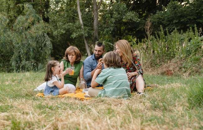 Happy family eating together at park model released, Symbolfoto, JCCMF06833