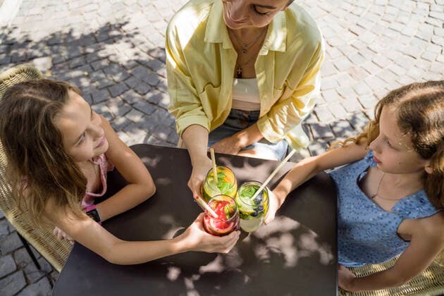 Smiling mother and daughters toasting cocktails with cane straw model released, Symbolfoto property released, OSF00470