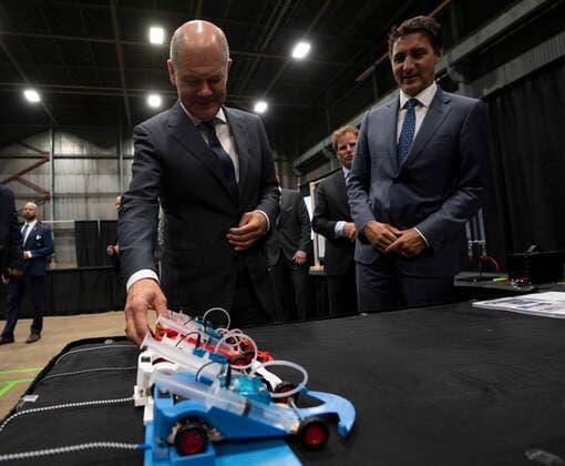 August 23, 2022, Stephenville, NFLD, Canada: Canadian Prime Minister Justin Trudeau looks on as German Chancellor Olaf Scholz examines a hydrogen powered model car as they tour a trade show, Tuesday, August 23, 2022 in Stephenville, Newfoundland and Labrador. Stephenville Canada  - ZUMAc35_ 20220823_zaf_c35_055 Copyright: xAdrianxWyldx