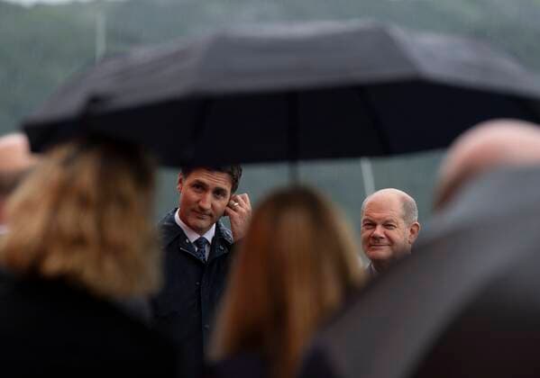 August 23, 2022, Stephenville, NFLD, Canada: Canadian Prime Minister Justin Trudeau adjusts his translation aid as he listens to a question from German media with German Chancellor Olaf Scholz during a joint availability on Tuesday, August 23, 2022 in Stephenville, Newfoundland and Labrador. Stephenville Canada  - ZUMAc35_ 20220823_zaf_c35_074 Copyright: xAdrianxWyldx