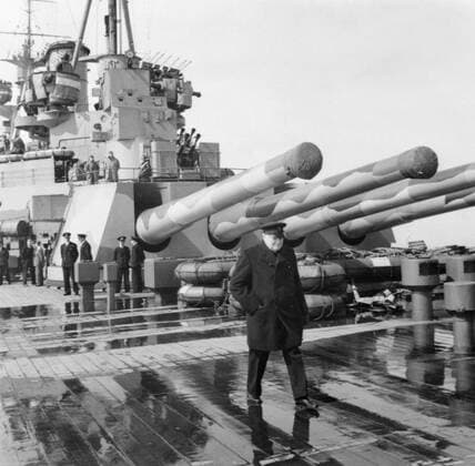 Winston Churchill on board the battleship HMS Prince of Wales during his journey to North America to meet President Roosevelt, August 1941. The Prime Minister Winston Churchill on board HMS Prince of Wales during his journey to North America to meet with President Roosevelt. The quadruple 14 inch guns of Y turret is visible in the background. Copyright: xpiemagsx warofficeww2pie5222-7071 !ACHTUNG AUFNAHMEDATUM GESCHÄTZT!