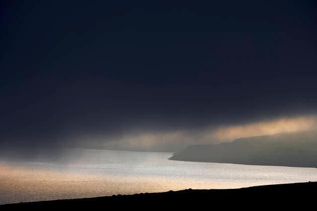 Cloudy sunset sky over sea and hills Hvalfjarðarsveit, Iceland CR_OSBJ220822-1029171-01