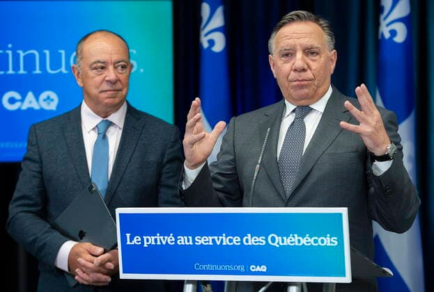 September 3, 2022, Montreal, PQ, Canada: Coalition Avenir Quebec outgoing health minister Christian Dube, left, looks on as CAQ Leader Francois Legault speaks at a news conference during an election campaign stop in Montreal, Saturday, Sept. 3, 2022. Quebecers will go to the polls on October 3rd. Montreal Canada  - ZUMAc35_ 20220903_zaf_c35_001 Copyright: xGrahamxHughesx