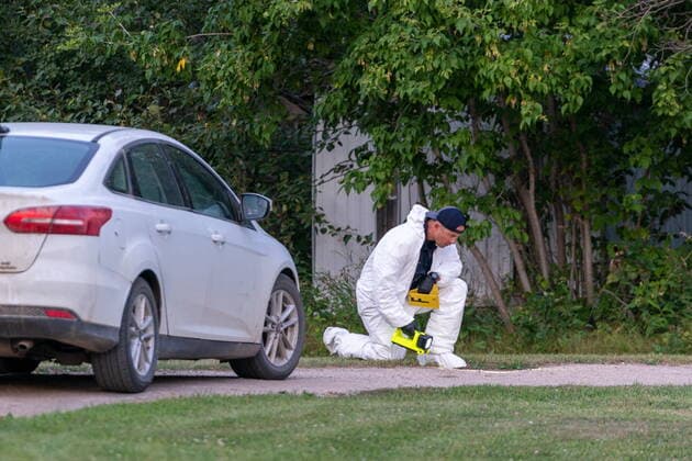 September 4, 2022, Weldon, SK, Canada: An investigator in protective equipment looks onto the ground at a crime scene in Weldon, Sask., on Sunday, Sept. 4, 2022. Saskatchewan RCMP has confirmed that there are 10 dead while 15 are injured following the stabbings that occurred at James Smith Cree Nation and Weldon in Saskatchewan. Weldon Canada  - ZUMAc35_ 20220904_zaf_c35_064 Copyright: xHeywoodxYux